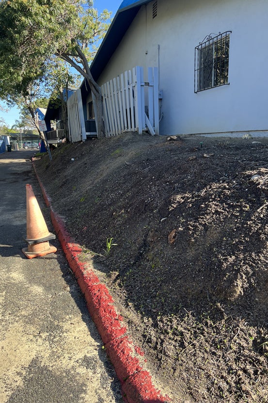 Dirt hill next to building
