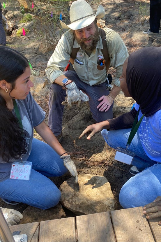 Two students talking with SDZWA team member
